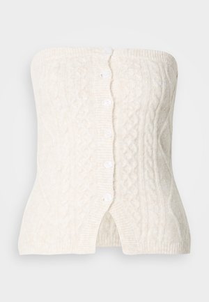 Creme strikket strapless top med cable mønster, fem knapper ned foran og et tætsiddende design med en let udvidelse ved kanten.