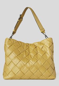 Yellow quilted leather handbag with padded adjustable shoulder strap and metallic clasps on a gray background.