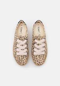 Beige leopard-print canvas sneakers with soft textured material, round toe, black accents, and contrasting light laces. Brand logo on side.