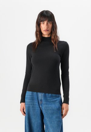 Black long-sleeve sweater with a high neck, made of a smooth fabric. Featuring a fitted design and visible ribbed hem detail.