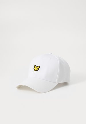 Casquette blanche avec un logo d'oiseau brodé jaune à l'avant. Le design comprend une visière courbée et une texture en tissu typique du coton.