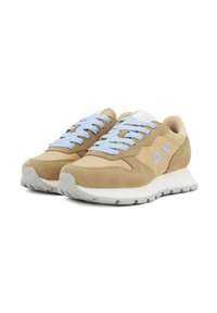 Beige suede sneakers with light blue laces, white accents, and a textured gray sole. Features a logo on the side. Classic athletic style.