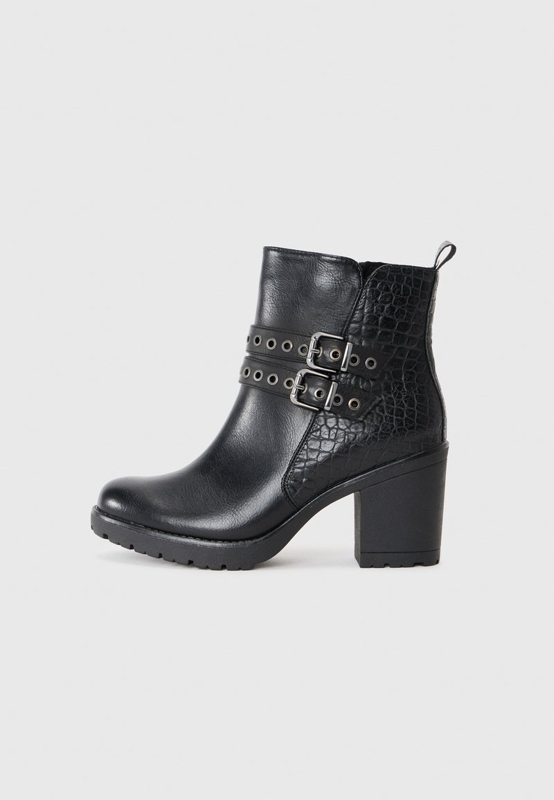 Black ankle boots made from smooth and embossed leather, featuring dual buckle straps, a chunky heel, and a textured side panel.