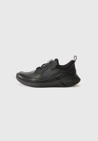 Black athletic shoe with a streamlined design, featuring a textured upper, mesh accents, a pull tab, and a lace-free closure system.