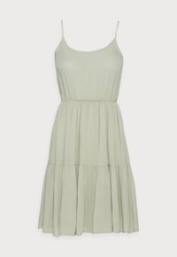 Ljusgrön solklänning med spaghettistövlar, ribbad textur och ett lager på lager-skjort. Har ett elastiskt midjeband för en bekväm passform.