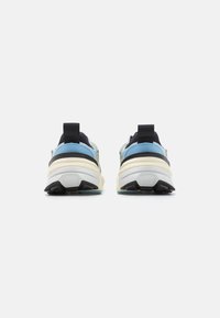 Athletic shoes featuring a mix of light blue and black materials, padded collar, and textured white sole with black accents.
