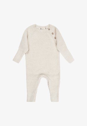 Cremfarbener gestrickter Baby-Overall mit langen Ärmeln und drei Knöpfen an der linken Schulter, Größe 56 Etikett sichtbar.