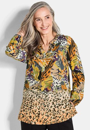 Langärmlige Bluse mit einem mehrfarbigen Blumen- und Leopardenmuster, einem V-Ausschnitt und Raffung an den Schultern.