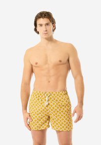 Pantaloni da bagno gialli con motivo circolare, dotati di una vita con cordino e una vestibilità comoda. Il materiale sembra leggero e traspirante.