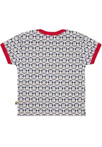 Kurzarm-T-Shirt aus cremefarbenem Stoff mit einem wiederholten blauen Affengesichtsmuster und roten Rippbündchen am Halsausschnitt und den Ärmeln.