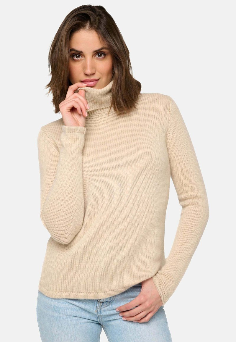Beige Rollkragenpullover mit gerippter Textur und langen Ärmeln, der eine lässige Passform sowie eine subtile Nahtdetails am Kragen aufweist.