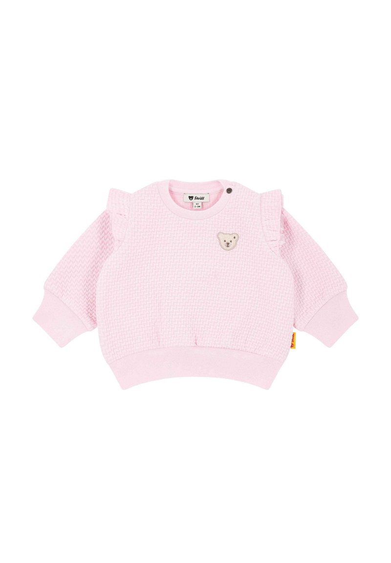 Pink toddler sweatshirt with textured fabric, ruffle accents on shoulders, round neckline, and a bear patch on the front. Ribbed cuffs and hem.