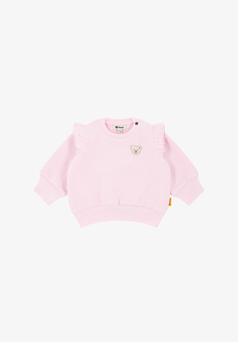 Pink toddler sweatshirt with textured fabric, ruffle accents on shoulders, round neckline, and a bear patch on the front. Ribbed cuffs and hem.