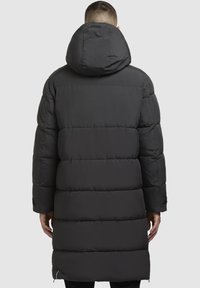 Sort pufferjakke med hætte, med en quiltet design, ribbede manchetter og midt-lår længde. Lynlåslommer i siderne.