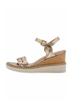 Wedge sandal in metallic gold with a woven strap, cork heel, and white rubber sole. Features a buckle for adjustable fit.