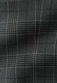 Woven fabric with a dark gray base and a check pattern in lighter gray and brown hues. Smooth texture with a structured appearance.