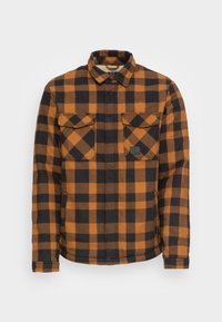 Orange- och svartrutigt flanellskjorta med knapp-ner-krage, två bröstfickor och subtil logotyp på nedre framsidan.