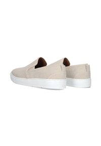 Beige instap schoenen van gestructureerde stof, met een lage profiel en witte rubberen zolen. De achterkant heeft een klein stoffen label.