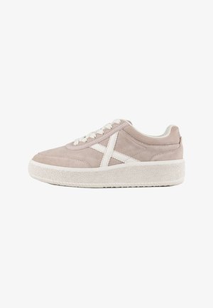 Light pink suede sneaker with white accents, textured rubber sole, round toe, and lace-up closure. Features an X design on the side.