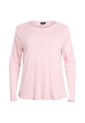 Jasnoróżowa koszula z długim rękawem, okrągłym dekoltem, wyposażona w zapięcie na guziki oraz falbaniasty dół. Wykonana z miękkiego materiału.