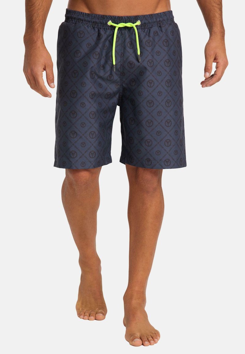 Men's swim shorts in dark navy blue with a diamond pattern and peace symbols. Features an elastic waistband with bright green drawstrings.