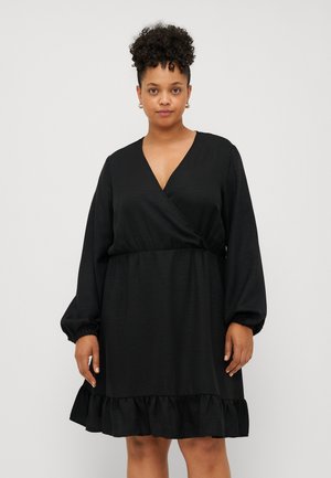 Black wrap dress with long, puffed sleeves, V-neckline, and a ruffled hem. Made from smooth fabric with a subtle sheen.