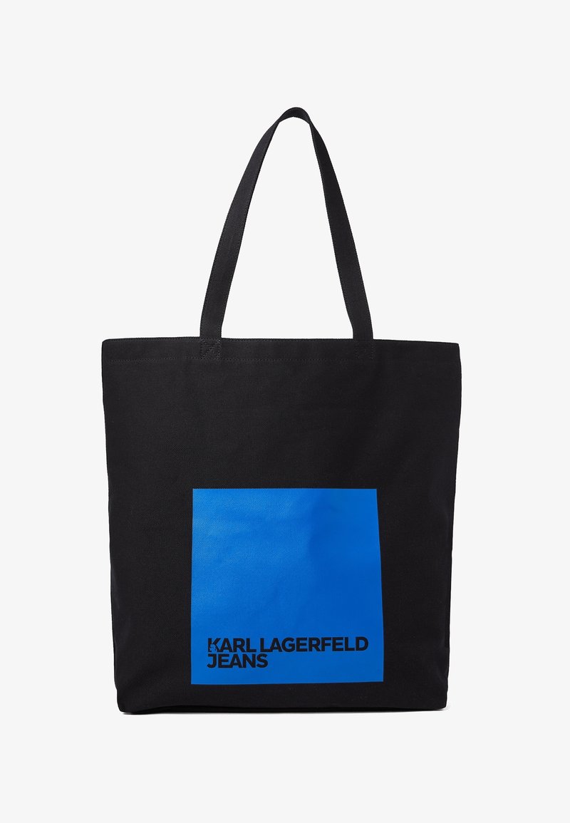 Black canvas tote bag featuring a large blue square graphic with “KARL LAGERFELD JEANS” text in bold black font at the bottom.