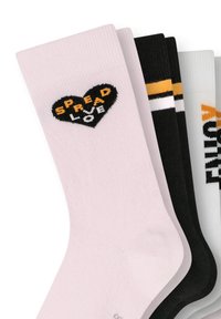 Cotton socks in pink, black, and white. Pink sock features a black heart with "SPREAD LOVE" in orange and white stripes on the black sock.