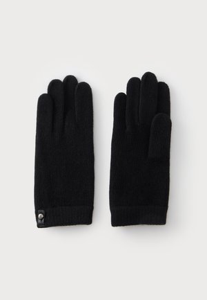 Par de guantes negros de punto con un pequeño detalle de botón en la muñeca, colocados planos sobre un fondo blanco liso.