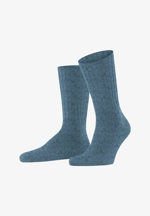 Chaussettes en mélange de coton de couleur bleu moyen, avec une texture côtelée, longueur mi-mollet, et renforts au niveau du talon et des orteils.