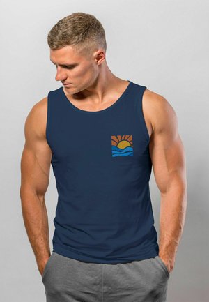 Dunkelblaues Tanktop mit Rundhalsausschnitt, das auf der linken Brustseite eine kleine Grafik einer Sonne und Wellen in Orange und Blau zeigt.