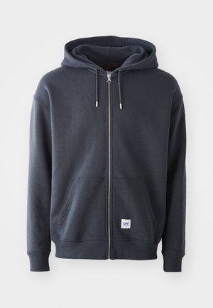 Dunkelgrauer Reißverschluss-Hoodie aus Baumwolle. Verfügt über eine Kapuze mit Kordelzug, Vordertaschen, gerippte Bündchen und ein kleines Logopatch am Saum.