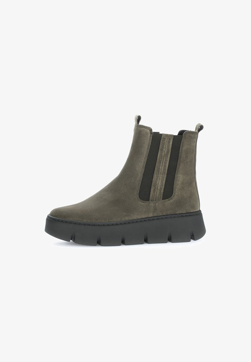 Olive green suede ankle boots with black elastic side panels and a thick black rubber sole featuring a tread pattern for grip.