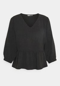 Blusa peplum nera con maniche lunghe a sbuffo, scollatura a V, tessuto testurizzato e dettagli di vita arricciati. Presenta una vestibilità liscia e leggermente fluida.