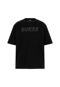 Must t-särk, mis on valmistatud puuvillast, ümara kaeluse ja lühikeste varrukatega. Ees on suur tumehall "GUESS" logo koos asutamiskuupäevaga.