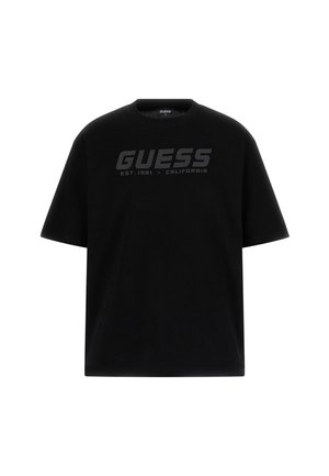 Fekete pamut póló, kerek nyakkivágással és rövid ujjakkal. Elöl egy nagy, sötétszürke "GUESS" logó található, amely mellett az alapítás dátuma is szerepel.
