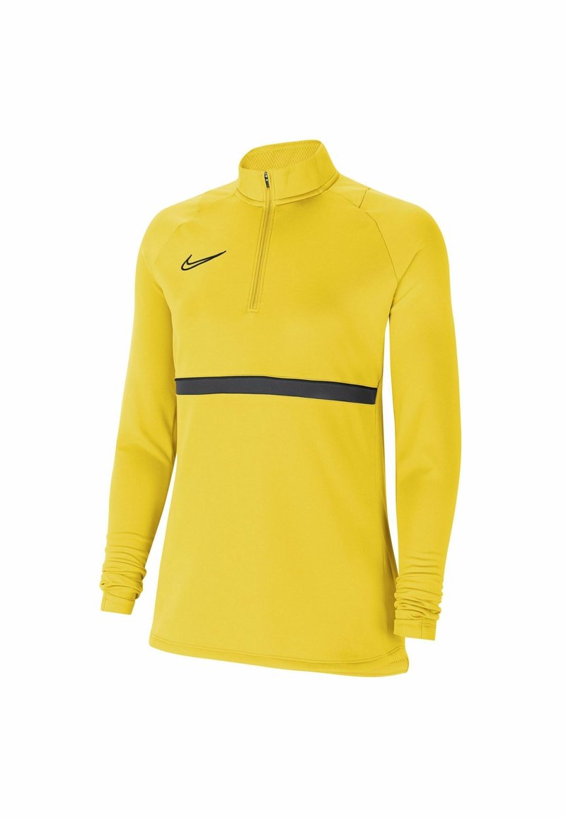 Haut de sport à manches longues jaune avec zip au quart, logo Nike noir sur la poitrine, et bande noire horizontale au niveau de la taille.