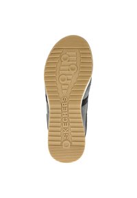Suela de zapato deportivo negra con una superficie de goma texturizada, que presenta ranuras y elementos circulares; marca "SKECHERS" cerca del talón.