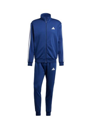 Dunkelblauer Trainingsanzug aus weichem Stoff, mit einer Zip-Jacke mit hohem Kragen, weißen Streifen an den Ärmeln und passenden, schmal zulaufenden Hosen.