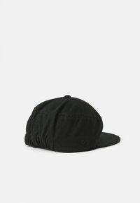 Black cap made of fabric with a rounded crown and flat brim. Features a gathered elastic back and stitching details.