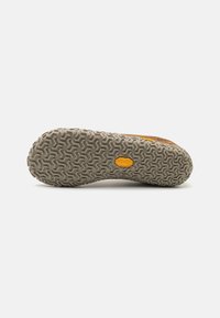 Rubber outsole with a zigzag pattern and light gray color. Features a textured surface and a logo detail near the heel.