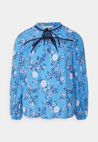 Blusa floral azul com decote franzido, bainha preta, mangas longas e punhos elásticos. Apresenta um padrão floral delicado em branco e azul escuro.