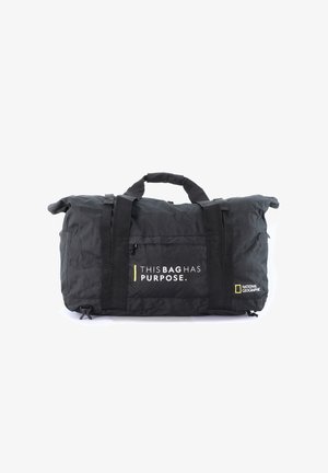 Black duffle bag with a textured fabric, adjustable nylon straps, top handles, and printed text: "THIS BAG HAS PURPOSE." with logo accents.