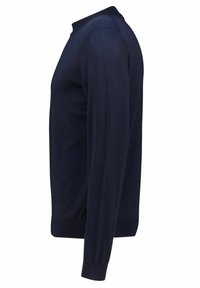 Tamsiai mėlynas megztinis, pagamintas iš lygaus megztinio audinio, su apvaliu iškirpimu ir ilgomis rankovėmis, su gipiūriniais rankogaliais ir apačia, suteikiančiais prigludusį vaizdą.