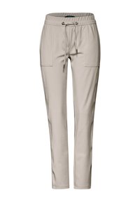 Beiga, stretchiga byxor med elastisk midja, dragsko och två framlängda fickor. Smalnande ben för en figurnära look.