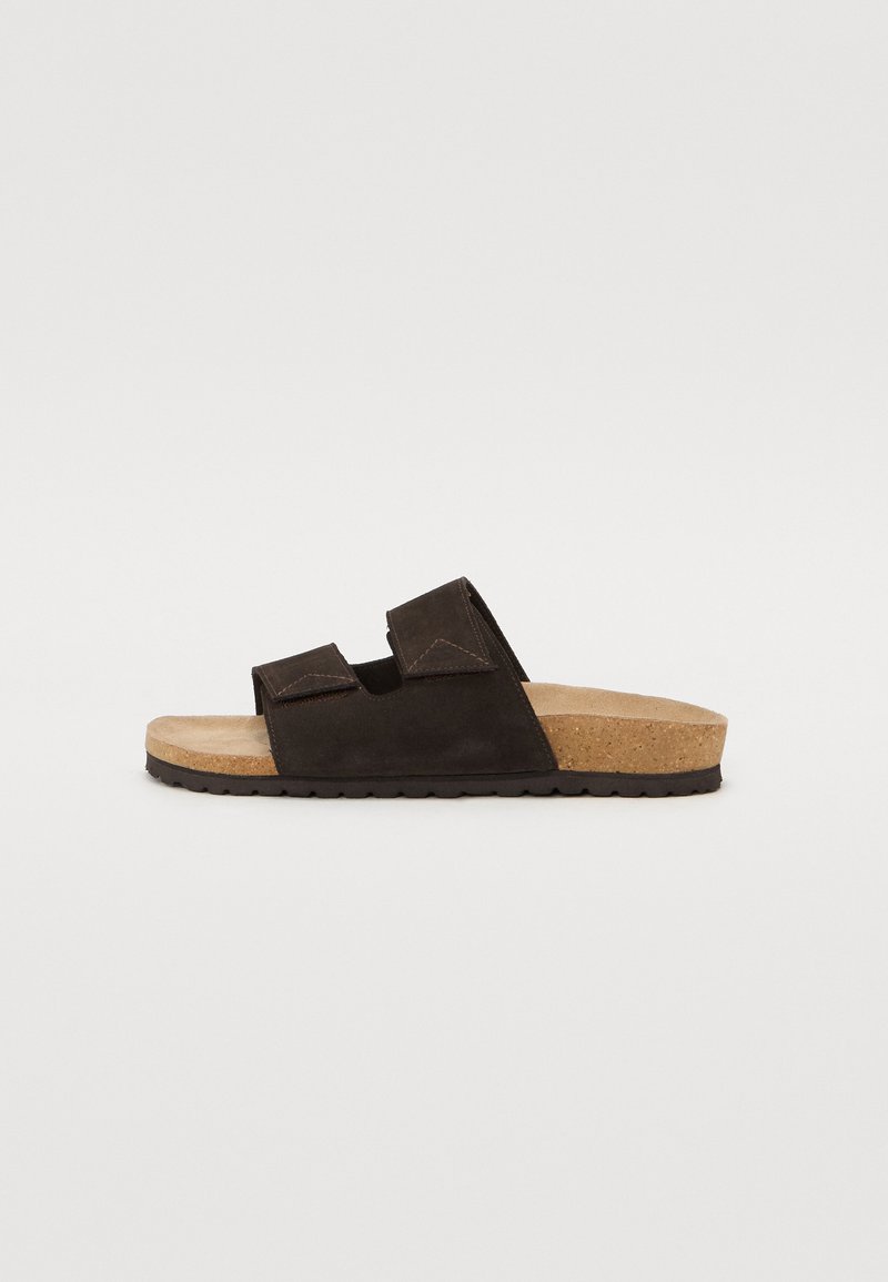 Black suede slide sandals with two adjustable straps, cork footbed, and textured rubber outsole. Simple, functional design.