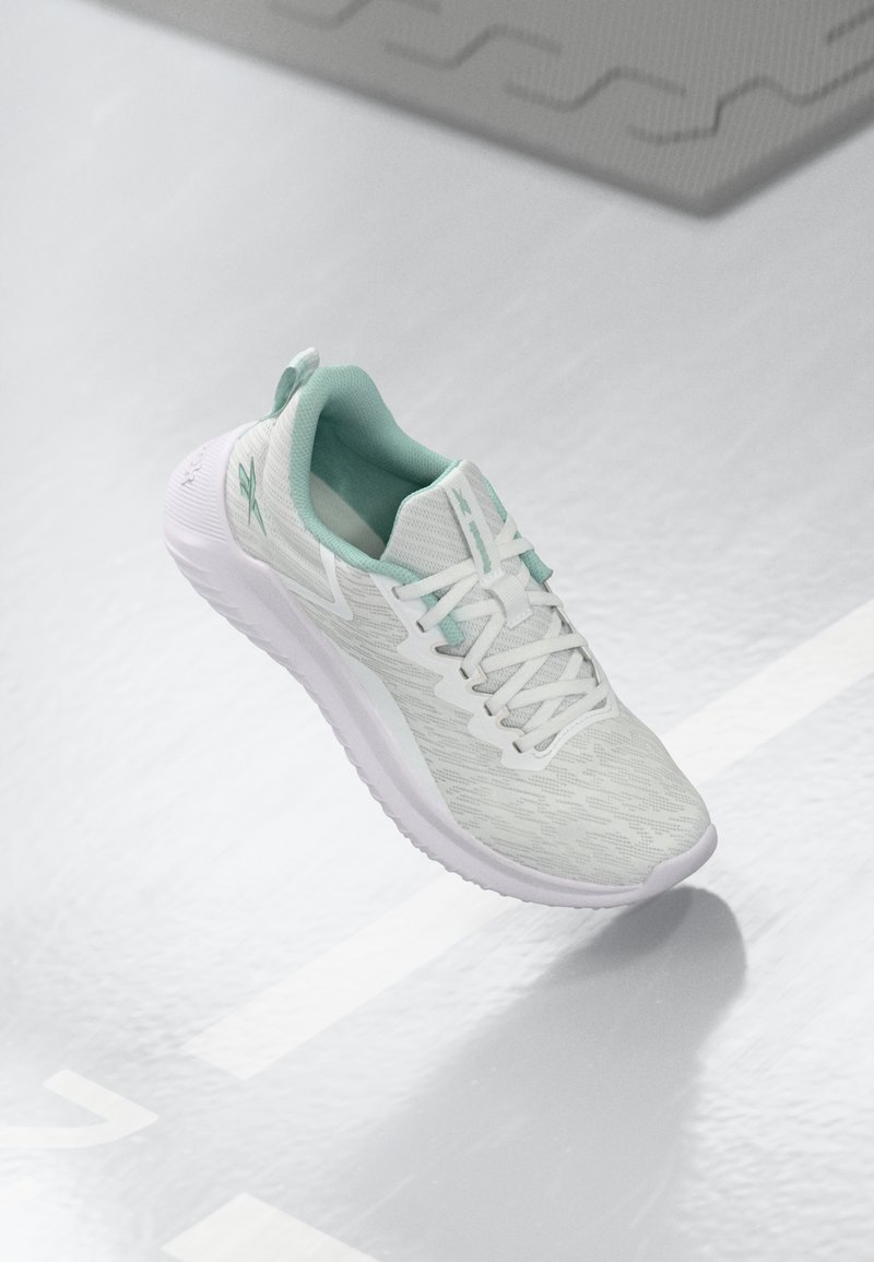 Light gray athletic shoe with a textured knit upper, mint green accents, white laces, rubber sole, and pull tab at the heel.