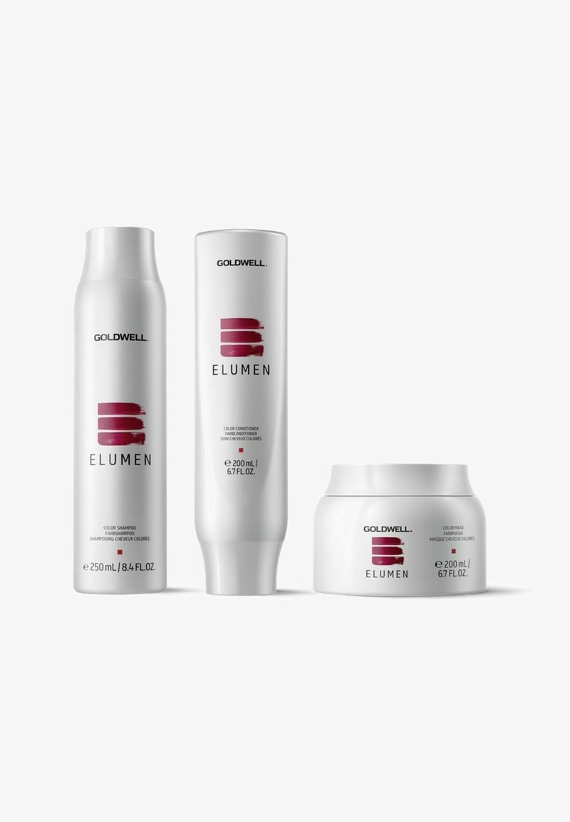 Three Goldwell Elumen hair care products: a white shampoo bottle, a white conditioner tube, and a white mask jar, featuring red accents and text.