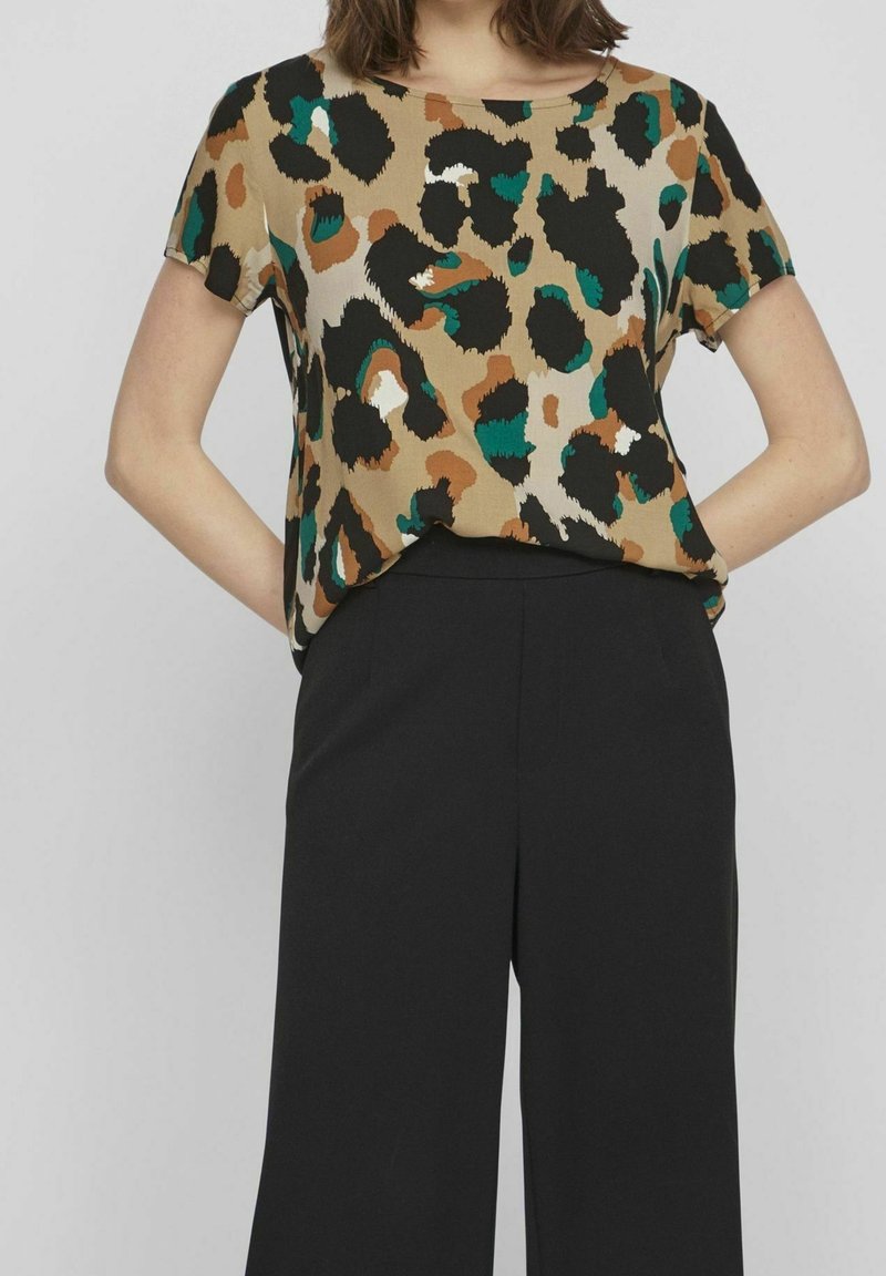 Blusa a maniche corte in tessuto beige con una stampa leopardata nera, verde e marrone; scollatura rotonda con una vestibilità comoda.
