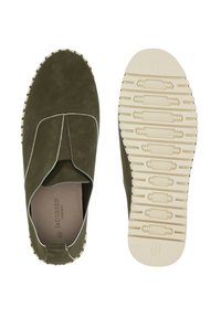 Olive green suede slip-on shoes with white stitching, elastic panels, and textured beige rubber sole featuring grip patterns.